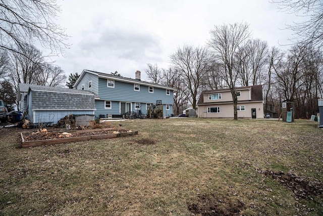 rear view of property with a lawn