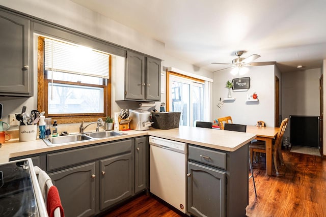 kitchen with kitchen peninsula, gray cabinets, stainless steel electric range, white dishwasher, and sink