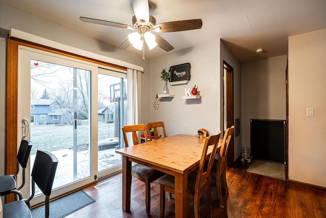 dining area featuring ceiling fan and dark wood-type flooring