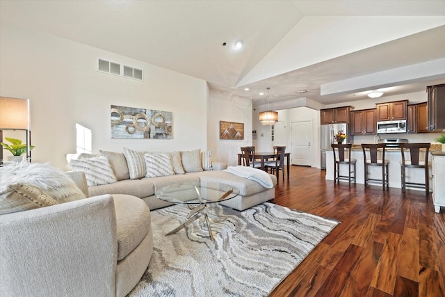 living room featuring high vaulted ceiling and dark wood-type flooring