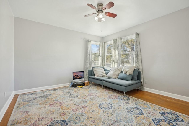 living area with ceiling fan and wood-type flooring