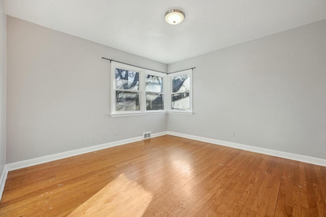 spare room with wood-type flooring