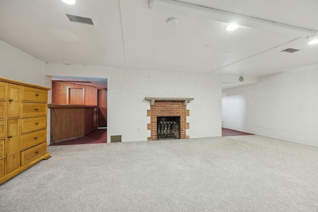 unfurnished living room featuring carpet floors and a fireplace