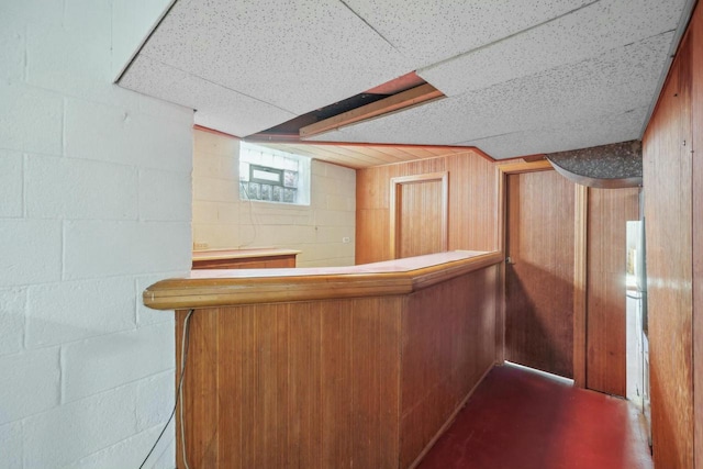 bar with a drop ceiling and wooden walls