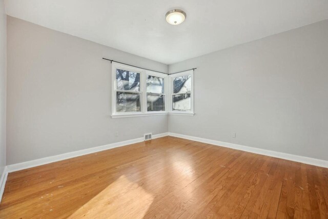 empty room with wood-type flooring