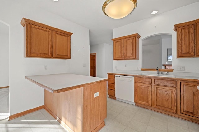 kitchen featuring white dishwasher, kitchen peninsula, and sink