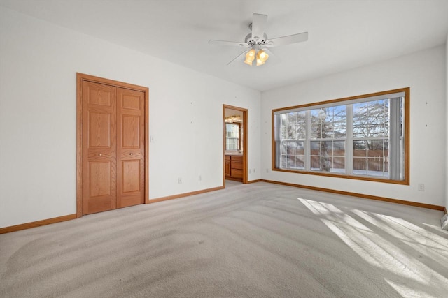 carpeted empty room featuring ceiling fan