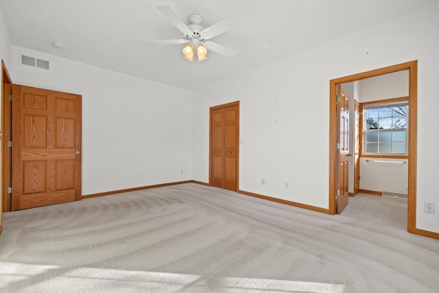 spare room featuring ceiling fan and light carpet