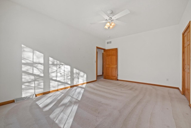 interior space featuring ceiling fan and light colored carpet