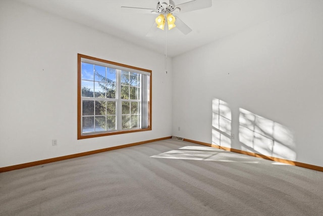 unfurnished room featuring light carpet and ceiling fan