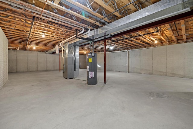 basement with electric water heater and heating unit