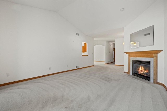 unfurnished living room featuring lofted ceiling, light colored carpet, and ceiling fan