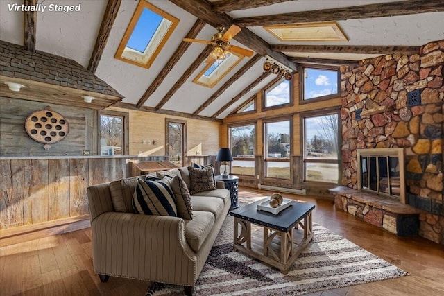 N4621 Lake Dr, Hustisford, WI 53034 - living room featuring ceiling fan, a skylight, beamed ceiling, and hardwood / wood-style flooring