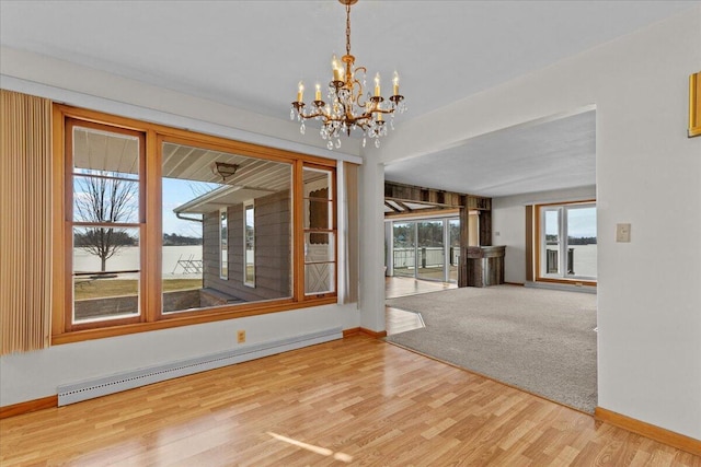 N4621 Lake Dr, Hustisford, WI 53034 - unfurnished dining area featuring hardwood / wood-style flooring, a baseboard heating unit, and a chandelier