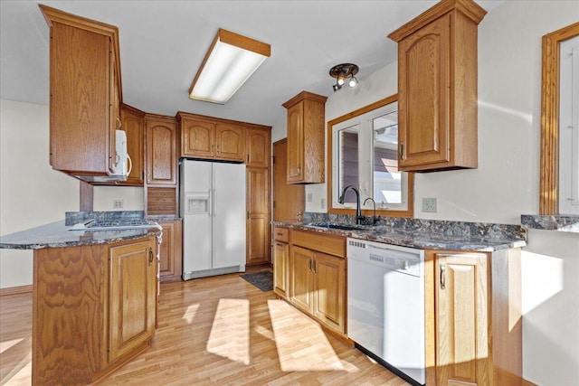 N4621 Lake Dr, Hustisford, WI 53034 - kitchen featuring dark stone counters, sink, white appliances, and light hardwood / wood-style flooring