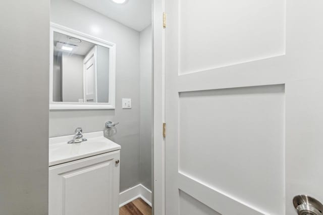 bathroom featuring hardwood / wood-style flooring and vanity