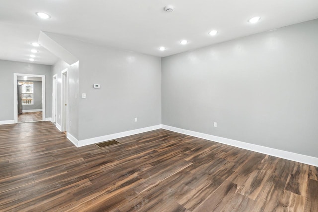 empty room featuring dark wood-type flooring