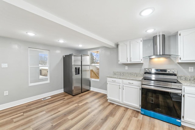 kitchen with appliances with stainless steel finishes, wall chimney exhaust hood, and white cabinetry