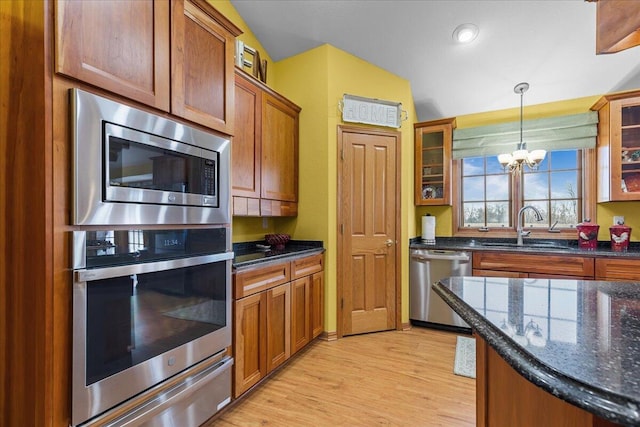 kitchen with light hardwood / wood-style floors, sink, hanging light fixtures, appliances with stainless steel finishes, and a chandelier