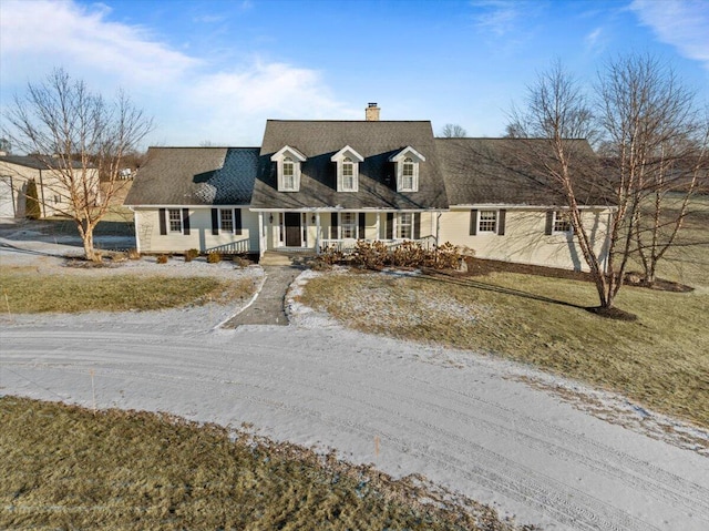 cape cod house with covered porch and a front yard