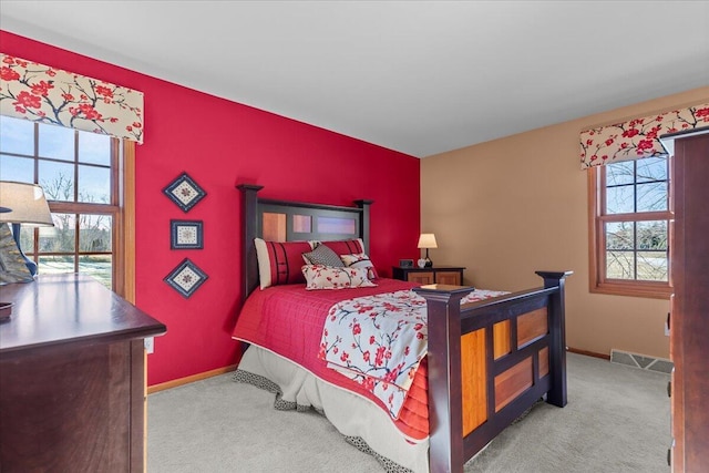 carpeted bedroom featuring multiple windows