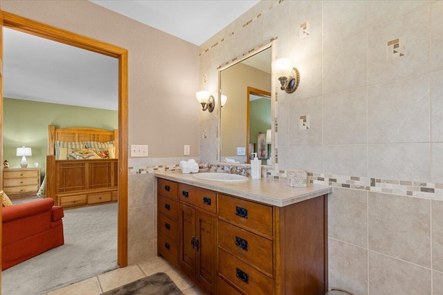 bathroom featuring tile patterned flooring, tile walls, and vanity