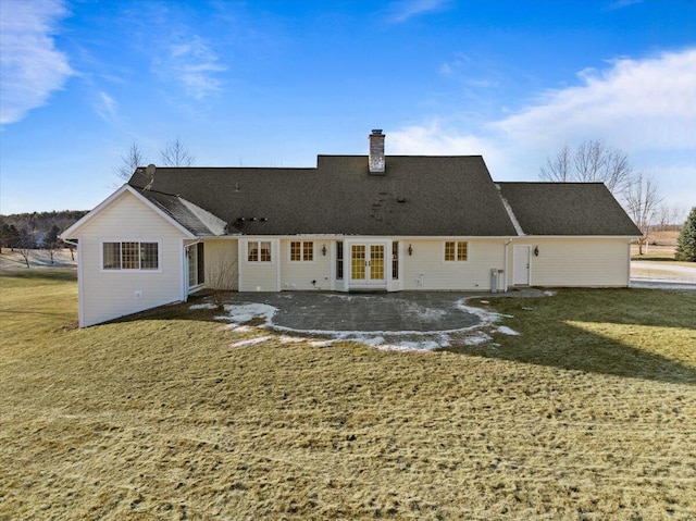 back of house with a lawn and french doors