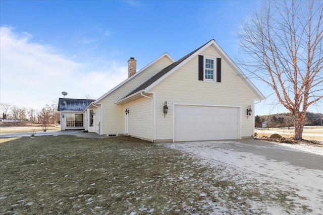 view of home's exterior featuring a garage and a yard