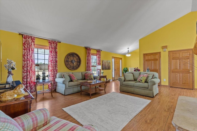 living room with lofted ceiling and light wood-type flooring