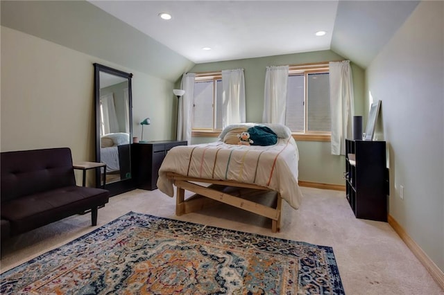 bedroom with lofted ceiling and light carpet