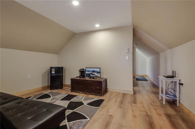 bonus room featuring vaulted ceiling and light hardwood / wood-style floors