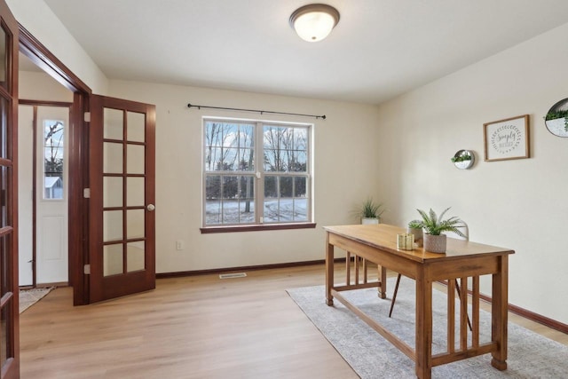 office area featuring french doors and light hardwood / wood-style flooring