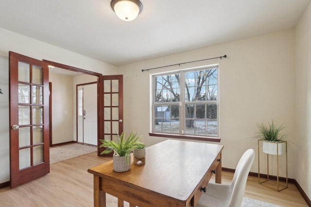 home office featuring light wood-type flooring and french doors