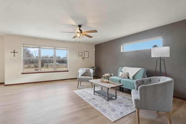 living room with ceiling fan and light hardwood / wood-style floors