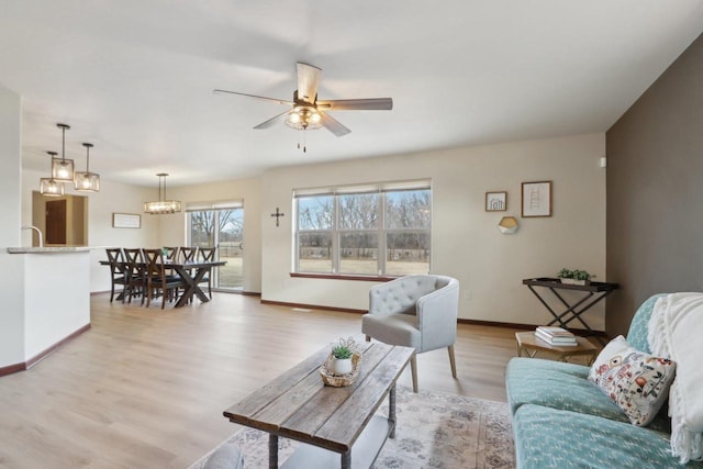 living room featuring ceiling fan and light wood-type flooring