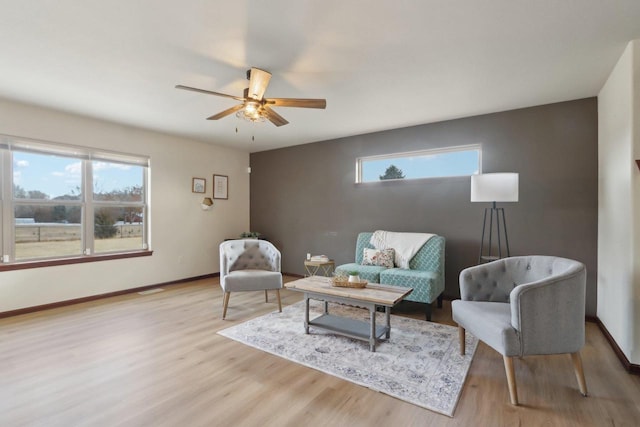 sitting room with ceiling fan and light hardwood / wood-style flooring