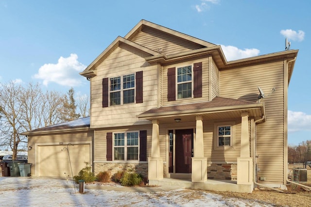 view of front of house with covered porch, a garage, and central AC