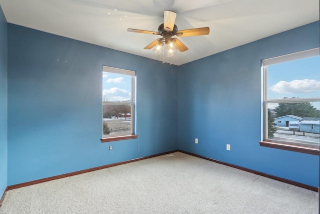 unfurnished room featuring carpet and ceiling fan