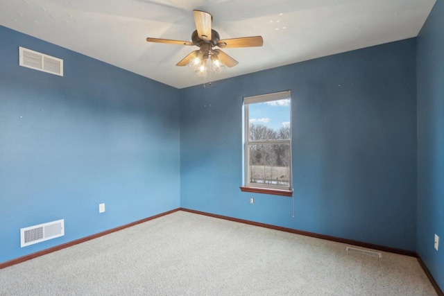 empty room featuring ceiling fan and carpet