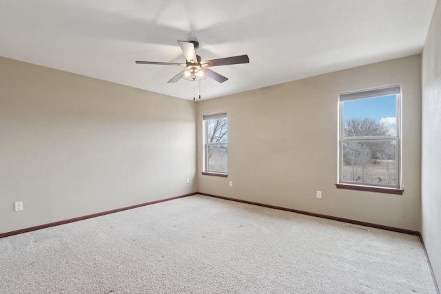 carpeted empty room featuring ceiling fan