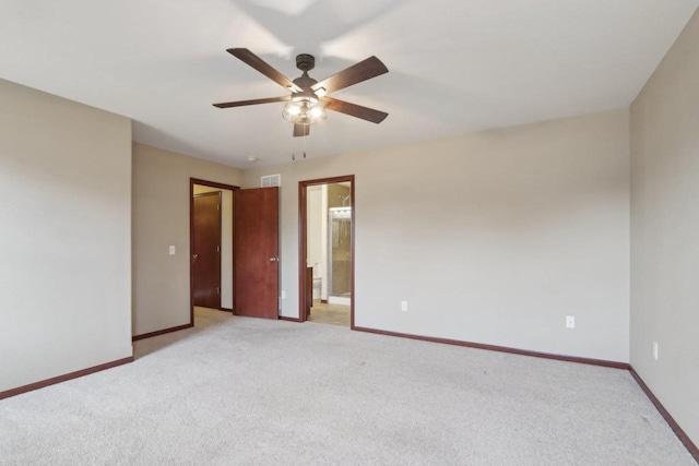 empty room with ceiling fan and light carpet