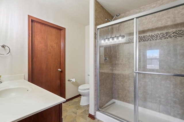 bathroom with a shower with door, toilet, and vanity