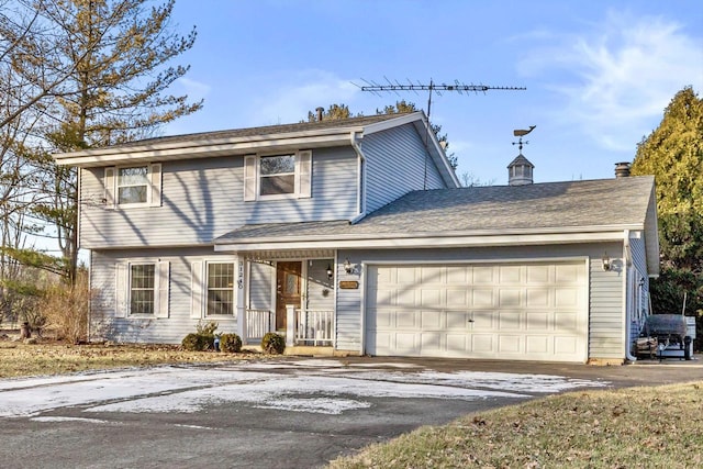 view of front of property featuring a garage and covered porch