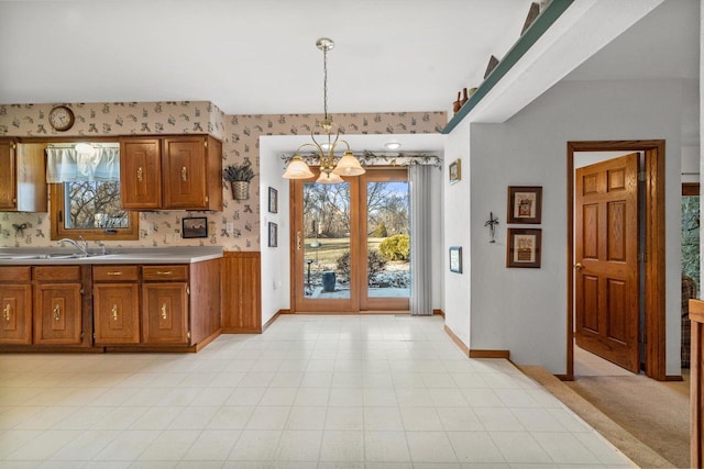 kitchen with sink, hanging light fixtures, and an inviting chandelier