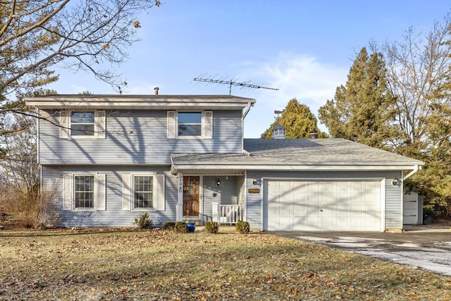 view of property with a garage and a front yard