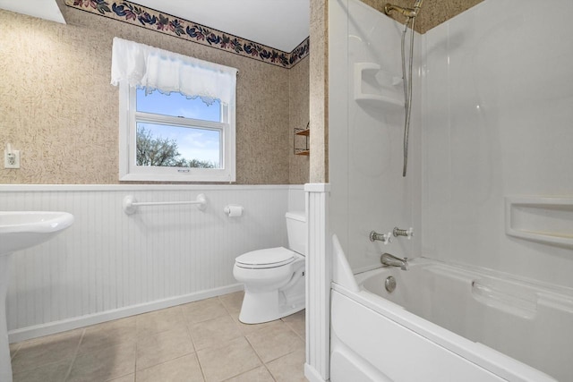 bathroom with tile patterned floors, shower / tub combination, and toilet