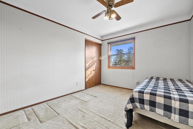 bedroom with ceiling fan and light colored carpet