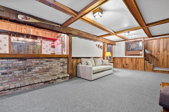 unfurnished living room featuring carpet, beam ceiling, bar, and coffered ceiling