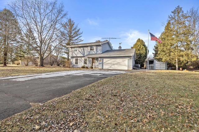 view of property featuring a front yard and a garage