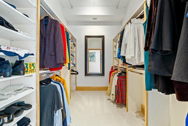 spacious closet featuring light colored carpet